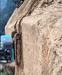 Mini excavator moves down vertical cliff - GIF-fake-angle2.jpg