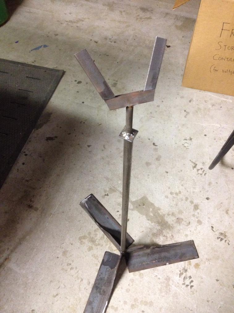 Tool stand:  grinder attachment.  It is made of three sections of 1" angle iron welded to a 1/2" rod that fits base pipe